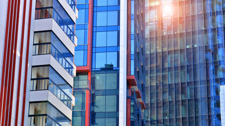 View of an modern apartment building standing next to a new modern office building with a glass facade.の写真素材