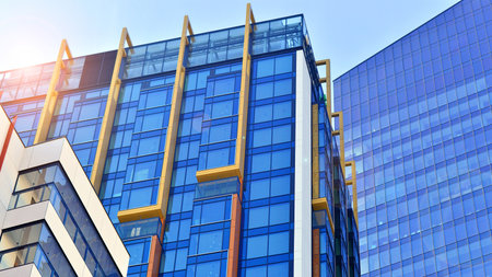View of an modern apartment building standing next to a new modern office building with a glass facade.の写真素材