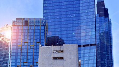 View of an modern apartment building standing next to a new modern office building with a glass facade.の写真素材