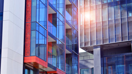View of an modern apartment building standing next to a new modern office building with a glass facade.の写真素材