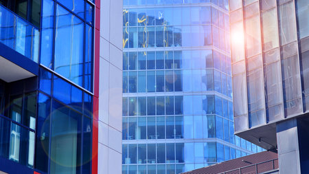 View of an modern apartment building standing next to a new modern office building with a glass facade.の写真素材