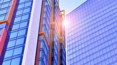 View of an modern apartment building standing next to a new modern office building with a glass facade.の写真素材