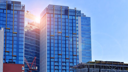 View of an modern apartment building standing next to a new modern office building with a glass facade.の写真素材
