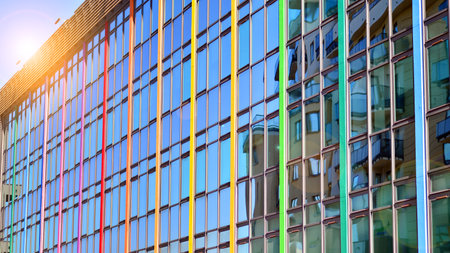 Structural glass wall reflecting blue sky. Abstract modern architecture fragment. Glass building with transparent facade of the building and blue sky. Contemporary architecturalの写真素材