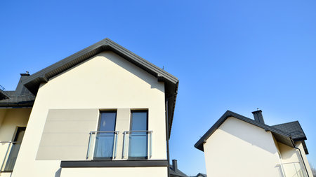 The real estate market in the suburbs. New single family houses in a new development area. Residential homes with modern facade. Terraced family homes in newly developed housingの写真素材