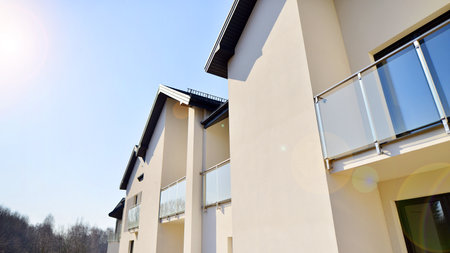 The real estate market in the suburbs. New single family houses in a new development area. Residential homes with modern facade. Terraced family homes in newly developed housingの写真素材