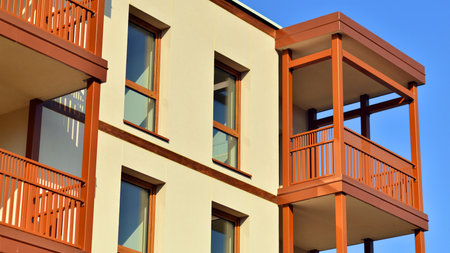 New apartment building. Residential area with modern apartment building. in sunny day. Fragments of the wooden facade.の写真素材