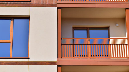 New apartment building. Residential area with modern apartment building. in sunny day. Fragments of the wooden facade.の写真素材