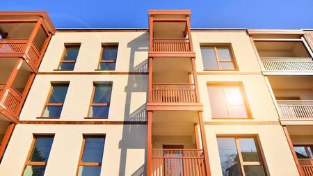 New apartment building. Residential area with modern apartment building. in sunny day. Fragments of the wooden facade.の写真素材