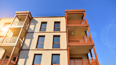 New apartment building. Residential area with modern apartment building. in sunny day. Fragments of the wooden facade.の写真素材