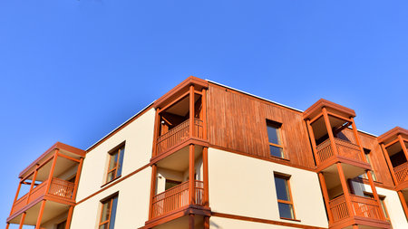 New apartment building. Residential area with modern apartment building. in sunny day. Fragments of the wooden facade.の写真素材