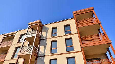 New apartment building. Residential area with modern apartment building. in sunny day. Fragments of the wooden facade.の写真素材