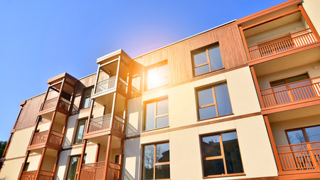 New apartment building. Residential area with modern apartment building. in sunny day. Fragments of the wooden facade.の写真素材
