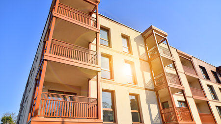 New apartment building. Residential area with modern apartment building. in sunny day. Fragments of the wooden facade.の写真素材