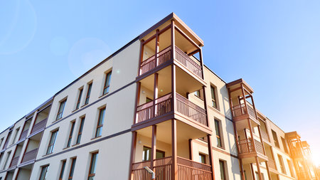 New apartment building. Residential area with modern apartment building. in sunny day. Fragments of the wooden facade.の写真素材