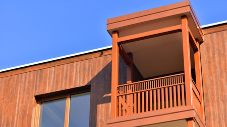 New apartment building. Residential area with modern apartment building. in sunny day. Fragments of the wooden facade.の写真素材