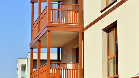 New apartment building. Residential area with modern apartment building. in sunny day. Fragments of the wooden facade.の写真素材