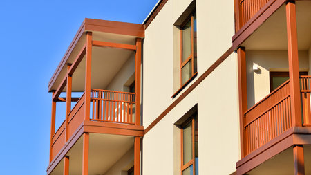 New apartment building. Residential area with modern apartment building. in sunny day. Fragments of the wooden facade.の写真素材