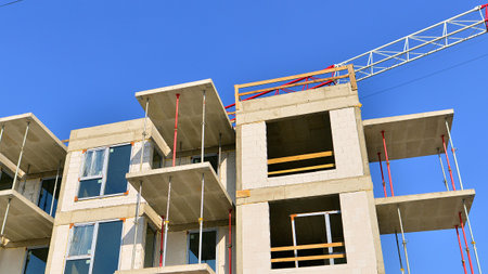 New multistory modern apartment buildings under construction in sunny day.の写真素材