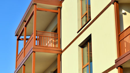 New apartment building. Residential area with modern apartment building. in sunny day. Fragments of the wooden facade.の写真素材