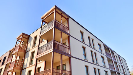 New apartment building. Residential area with modern apartment building. in sunny day. Fragments of the wooden facade.の写真素材