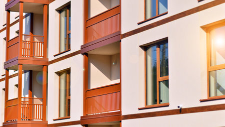 New apartment building. Residential area with modern apartment building. in sunny day. Fragments of the wooden facade.の写真素材