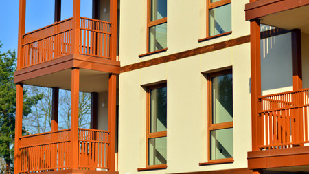 New apartment building. Residential area with modern apartment building. in sunny day. Fragments of the wooden facade.の写真素材