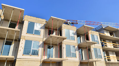 New multistory modern apartment buildings under construction in sunny day.の写真素材