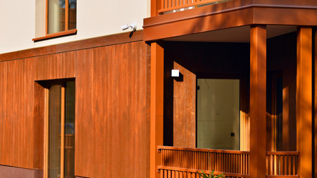 New apartment building. Residential area with modern apartment building. in sunny day. Fragments of the wooden facade.の写真素材