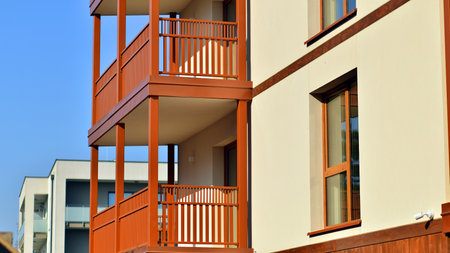 New apartment building. Residential area with modern apartment building. in sunny day. Fragments of the wooden facade.の写真素材