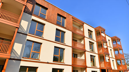 New apartment building. Residential area with modern apartment building. in sunny day. Fragments of the wooden facade.の写真素材