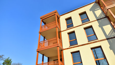 New apartment building. Residential area with modern apartment building. in sunny day. Fragments of the wooden facade.の写真素材