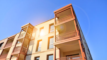 New apartment building. Residential area with modern apartment building. in sunny day. Fragments of the wooden facade.の写真素材