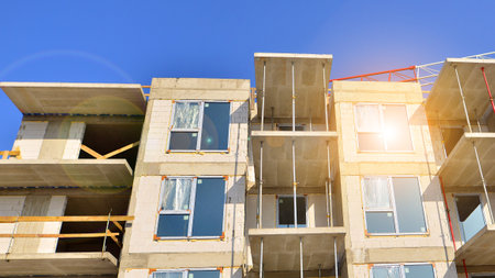 New multistory modern apartment buildings under construction in sunny day.の写真素材