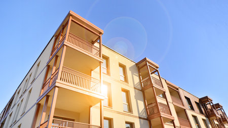 New apartment building. Residential area with modern apartment building. in sunny day. Fragments of the wooden facade.の写真素材