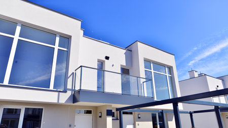 Terraced family homes in newly developed housing estate. The real estate market in the suburbs. New single family houses in a new development area. Residential homes with modern faの写真素材