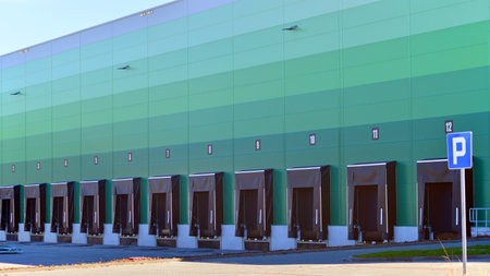 Facade of an industrial building and warehouse. Empty platforms at a distribution center.の写真素材