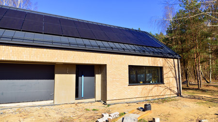 A suburban district of single-family homes. Single family house construction site. Modern designed single-family house under construction.の写真素材