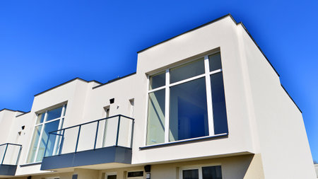 Terraced family homes in newly developed housing estate. The real estate market in the suburbs. New single family houses in a new development area. Residential homes with modern faの写真素材