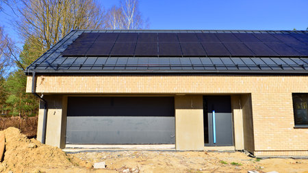 A suburban district of single-family homes. Single family house construction site. Modern designed single-family house under construction.の写真素材