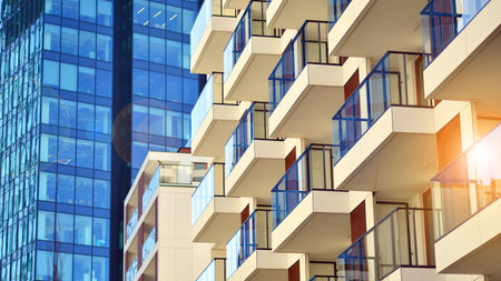 View of an modern apartment building standing next to a new modern office building with a glass facade.の写真素材