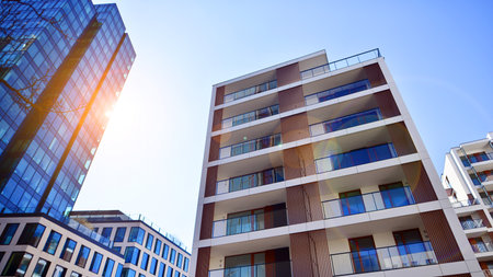 View of an modern apartment building standing next to a new modern office building with a glass facade.の写真素材
