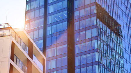 View of an modern apartment building standing next to a new modern office building with a glass facade.の写真素材