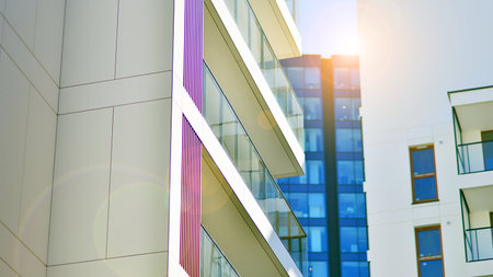 View of an modern apartment building standing next to a new modern office building with a glass facade.の写真素材
