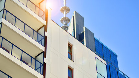 View of an modern apartment building standing next to a new modern office building with a glass facade.の写真素材