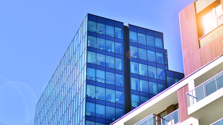 View of an modern apartment building standing next to a new modern office building with a glass facade.の写真素材