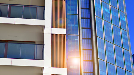 View of an modern apartment building standing next to a new modern office building with a glass facade.の写真素材
