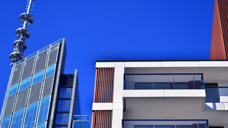 View of an modern apartment building standing next to a new modern office building with a glass facade.の写真素材