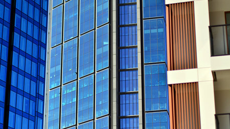 View of an modern apartment building standing next to a new modern office building with a glass facade.の写真素材
