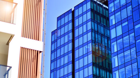 View of an modern apartment building standing next to a new modern office building with a glass facade.の写真素材